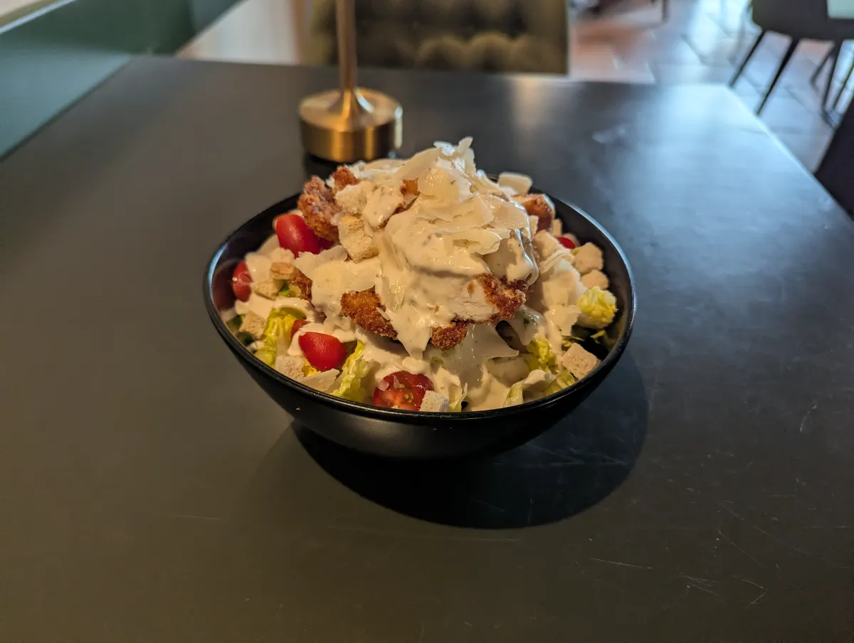 Caesarsalat — Romanasalat, Kirschtomate, Parmesan, Croutons, Caesardressing und Sauerteigbrot bei Kaspio in Stade